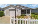 Front view of a single story home with white vinyl siding at 1106 Carvello Dr, The Villages, FL 32162