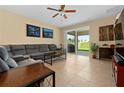 Spacious living room with tile floors, sectional sofa, and access to backyard at 2306 Kennington Cv, Deland, FL 32724