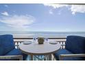 Oceanfront balcony with table and chairs at 4435 S Atlantic Ave # 414, Ponce Inlet, FL 32127