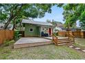 Spacious deck overlooking a fenced backyard with a firepit at 112 S Chandler Ave, Deland, FL 32724
