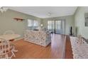 Living room with floral sofa and view to patio at 600 N Boundary Ave # 101A, Deland, FL 32720