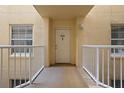 Condo entryway with white door and balcony access at 4650 Links Village Dr # B307, Ponce Inlet, FL 32127