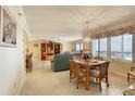 Bright dining area with ocean view and wood table at 1513 Ocean Shore Blvd # 3C, Ormond Beach, FL 32176