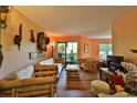Living area with bamboo furniture, wood floors, and access to balcony at 1401 S Palmetto Ave # 402, Daytona Beach, FL 32114