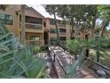 Condo building with walkway, tropical landscaping, and access to building at 1401 S Palmetto Ave # 402, Daytona Beach, FL 32114