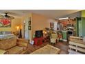 Open living room with bamboo furniture, kitchen, and wood floors at 1401 S Palmetto Ave # 402, Daytona Beach, FL 32114