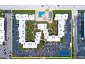 Top-down view of condo complex with ample parking and tennis court at 4175 S Atlantic Ave # 1130, New Smyrna Beach, FL 32169