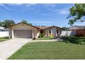 House exterior with a garage and a landscaped yard at 1373 Verona St, Daytona Beach, FL 32114