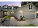 Attractive single-story home at dusk, featuring a two-car garage and well-manicured landscaping at 1117 Athlone Way, Ormond Beach, FL 32174