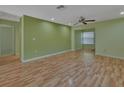 Bright living room featuring laminate wood floors and soft green walls at 13 Villa Villar # 0, Deland, FL 32724