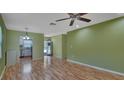 Open living area with hardwood floors and a view of the kitchen at 13 Villa Villar # 0, Deland, FL 32724