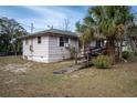 Side view of pink house needing renovation at 1502 Carver, Deland, FL 32720