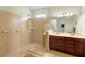 Large walk-in shower, double vanity, and tile flooring at 309 Chesham St, Ormond Beach, FL 32174