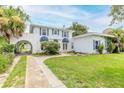 Two-story house with white exterior, blue accents and a lush lawn at 724 N Oleander Ave, Daytona Beach, FL 32118