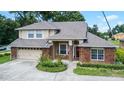 Brick house with a two-car garage and landscaped yard at 1401 Bent Oaks Blvd, Deland, FL 32724