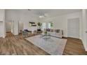Bright living room featuring a comfy couch and large windows at 210 E Baxter St, De Leon Springs, FL 32130