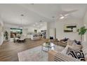 Open concept living room and kitchen with wood-look tile floors at 210 E Baxter St, De Leon Springs, FL 32130