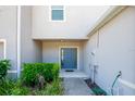 Private entrance to a townhome with a blue door and landscaping at 1610 Primo Ct, Holly Hill, FL 32117