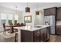 Open kitchen with large island, stainless steel appliances, and breakfast bar at 6287 Woodhaven Village Dr, Port Orange, FL 32128