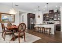 Open concept kitchen with island, stainless steel appliances, and hardwood floors at 6287 Woodhaven Village Dr, Port Orange, FL 32128