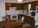 Cozy kitchen with wood cabinets and dining area at 1418 Catalina Blvd, Deltona, FL 32725