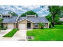 Front view of house with lawn and driveway at 34 Fairway Dr # 1, Debary, FL 32713