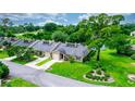 Aerial view of a lovely villa nestled in a community with a lake at 34 Fairway Dr # 1, Debary, FL 32713