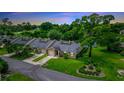 Aerial view of charming villa with lake access and lush landscaping at 34 Fairway Dr # 1, Debary, FL 32713