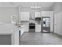 Modern kitchen with stainless steel appliances and white cabinets at 1790 17Th St, Orange City, FL 32763