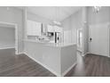 Modern kitchen with white cabinets and island at 1790 17Th St, Orange City, FL 32763