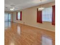 Bright living room featuring hardwood floors, ceiling fan, and sliding glass doors at 47 Villa Villar Ct # 470, Deland, FL 32724