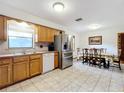 Kitchen with wood cabinets, stainless steel appliances, and a view of backyard at 106 N Frederick St, Pierson, FL 32180
