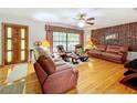 Bright living room featuring hardwood floors and comfortable leather seating at 106 N Frederick St, Pierson, FL 32180