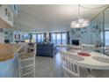 Bright dining area with ocean view and white table at 3115 S Atlantic Ave # 703, Daytona Beach Shores, FL 32118