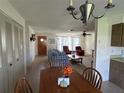 Dining area with wooden table and chairs, open to living room at 1612 Juno Trl, Astor, FL 32102