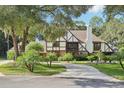 Two-story house with a circular driveway and landscaping at 1582 Covered Bridge Dr, Deland, FL 32724