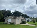 Tan single story house with a large backyard at 1415 Talton Ave, Deland, FL 32720