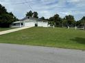 House with a large yard, a white fence, and a two-car garage at 1757 W Acadian Dr, Deltona, FL 32725