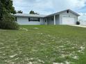Single-story house with attached garage, and a large grassy yard at 1757 W Acadian Dr, Deltona, FL 32725