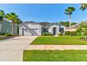 Single-story house with gray siding and landscaped yard at 117 Boysenberry Ln, Daytona Beach, FL 32124