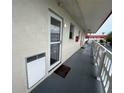 Exterior hallway view with white railings and individual condo entry doors at 2901 N Halifax Ave # 219, Daytona Beach, FL 32118