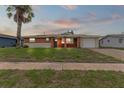 Brick ranch home with a one-car garage and manicured lawn at 22 Morning Star Ave, Ormond Beach, FL 32176