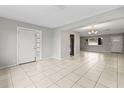 Open concept living area with tile floors and access to the kitchen at 22 Morning Star Ave, Ormond Beach, FL 32176