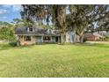 House exterior, showcasing a light blue home with stone accents at 573 Pelican Bay Dr, Daytona Beach, FL 32119