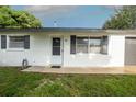 White brick ranch house with gray shutters and garage door at 1809 Green Pl, Ormond Beach, FL 32174