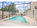 Refreshing screened-in pool with a water feature at 2291 Henry Ln, Deltona, FL 32738