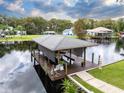 Covered boat dock with a spacious deck and walkway, offering waterfront access at 1633 Yellow Brick Rd, Astor, FL 32102