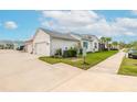 White home with teal accents and two-car garage at 623 Margaritaville Ave, Daytona Beach, FL 32124