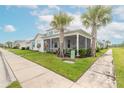 White home with teal accents and screened porch at 623 Margaritaville Ave, Daytona Beach, FL 32124