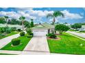 Single story home with a lush green lawn and palm trees at 399 Foxhill Dr, Debary, FL 32713